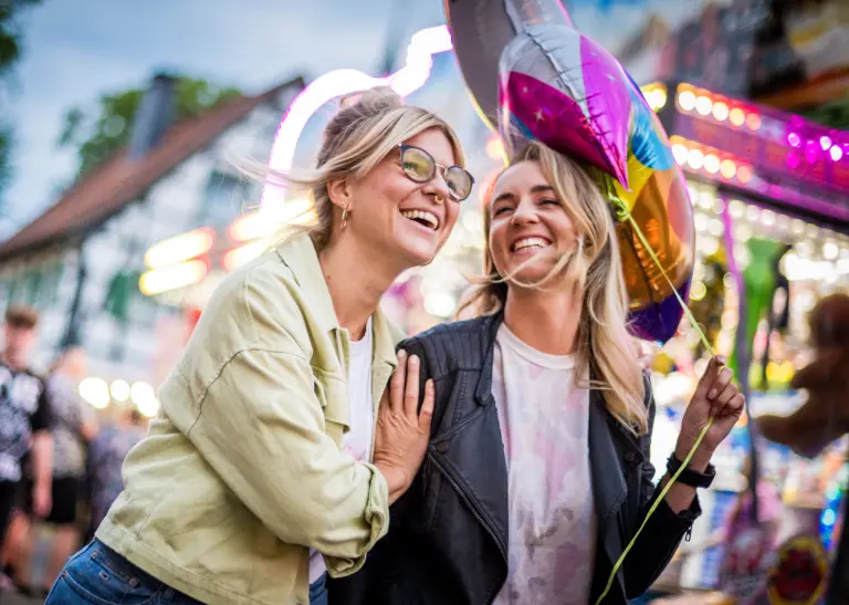 Zwei junge Frauen haben Spaß auf der Kirmes.