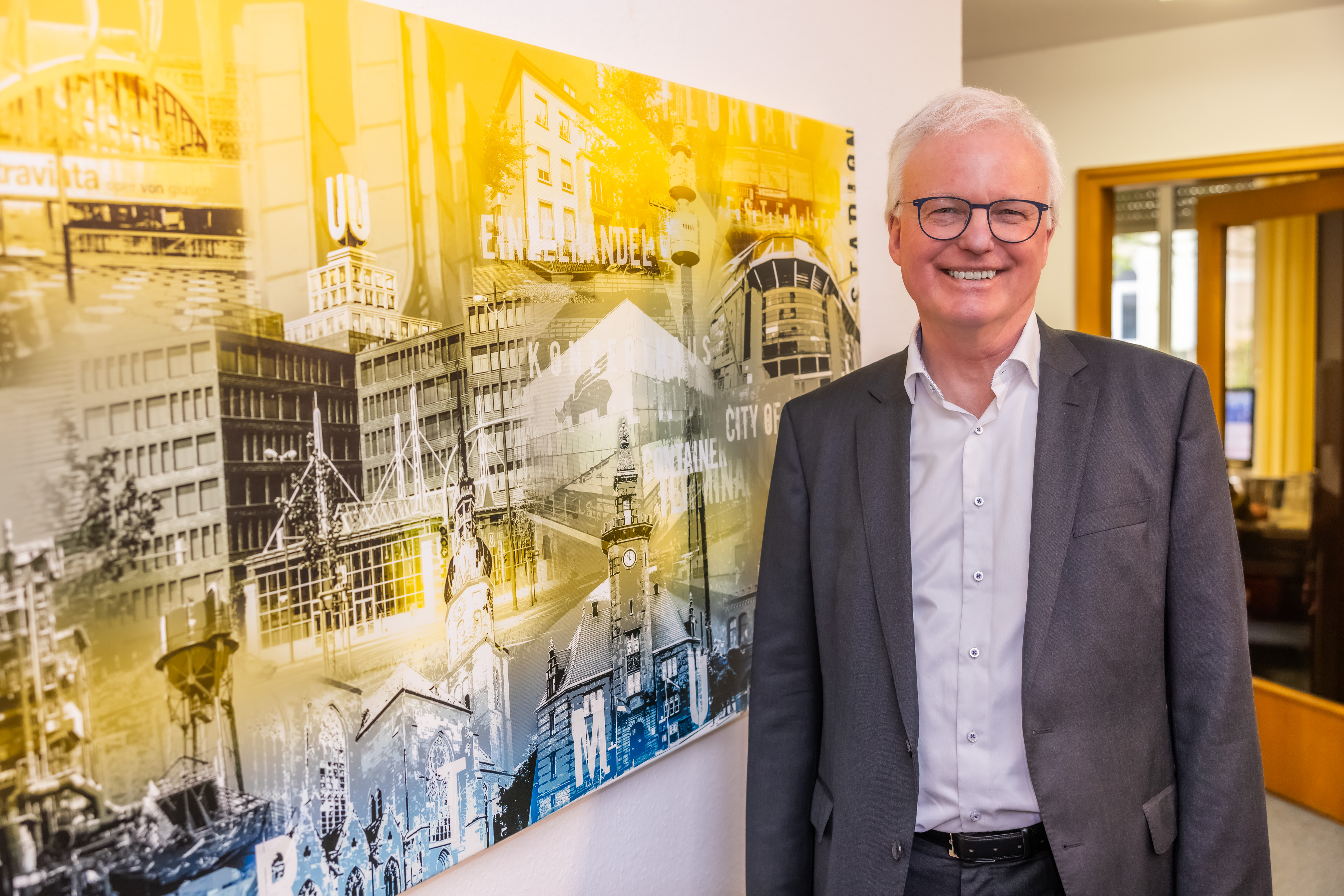 Foto eines Mannes neben einem Gemälde der Dortmunder City.